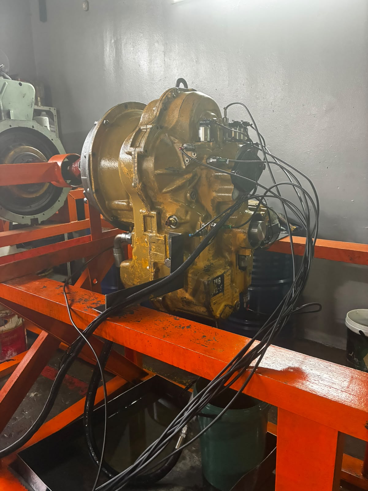 Heavy-duty transmission mounted on an orange workshop rig